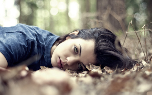 Woman lying woods bokeh blurry free wallpaper - medium preview image