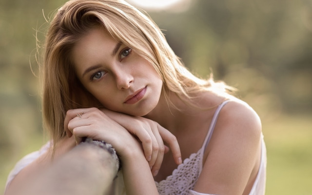 Woman leaning rail serious portrait free wallpaper - medium preview image