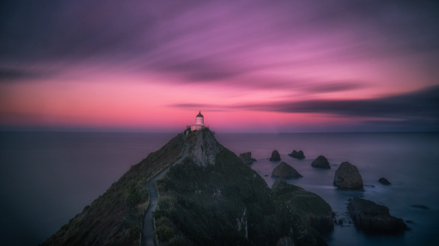 Lighthouse rocky cliff purple sunset free wallpaper - medium preview image