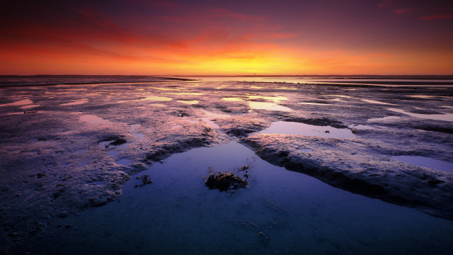 Sunset water ice rocks footprints free wallpaper - medium preview image