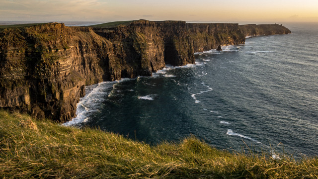 Cliff water grassy hill panorama free wallpaper - medium preview image