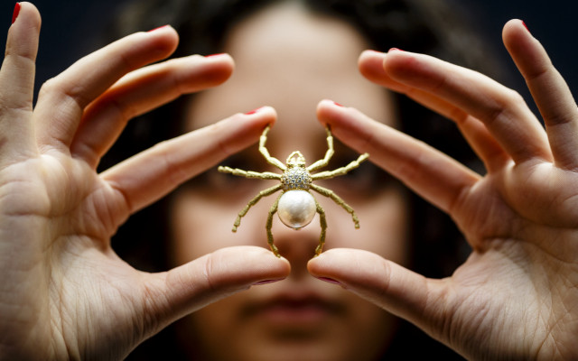 Woman holding spider pearl feminist free wallpaper - medium preview image