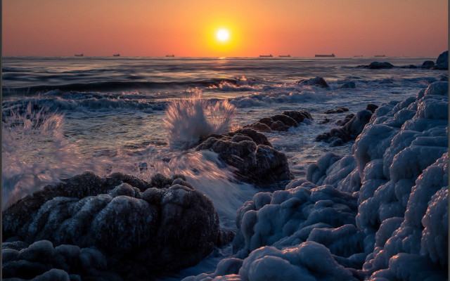 Sunset ocean waves rocks boat free wallpaper - medium preview image