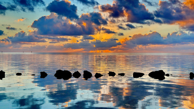 Sunset ocean rocks clouds city free wallpaper - medium preview image