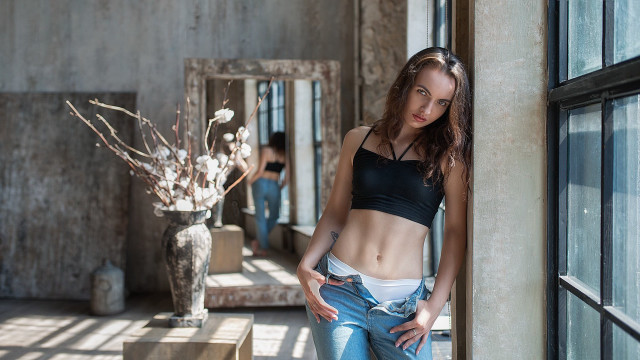 Woman black top leaning wall free wallpaper - medium preview image