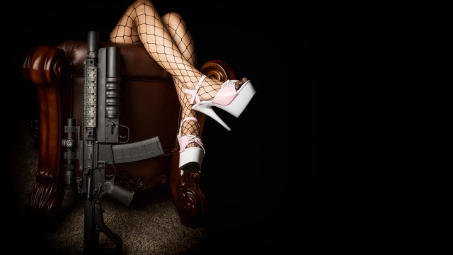 Woman fishnet stockings gun chair free wallpaper - medium preview image