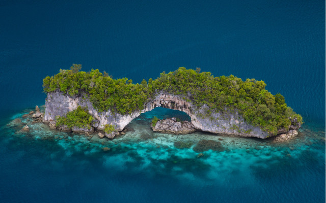 Island cave surrounded by water free wallpaper - medium preview image