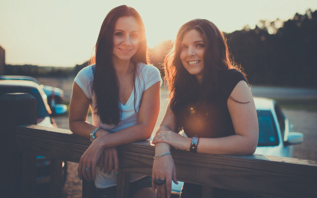 Two women bench truck sunset free wallpaper - medium preview image