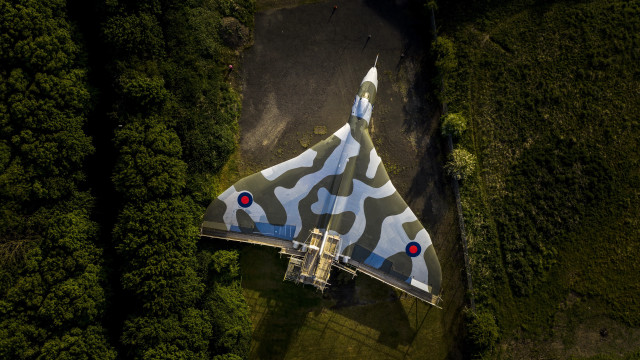 Camouflaged jet tiltshift forest reddot free wallpaper - medium preview image