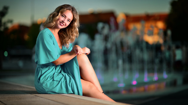 Woman sitting fountain smiling portrait free wallpaper - medium preview image