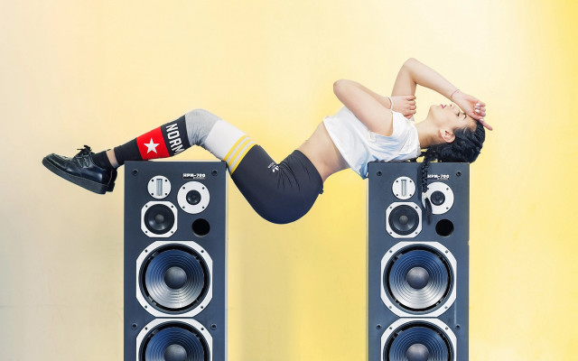 Woman handstand speakers yellow background free wallpaper - medium preview image