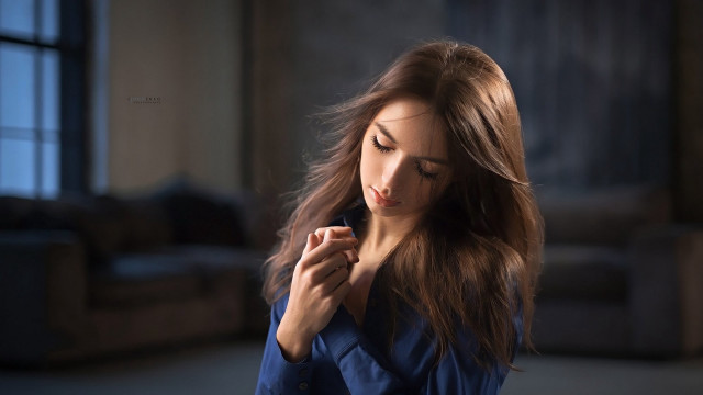 Serious woman blue coat portrait free wallpaper - medium preview image
