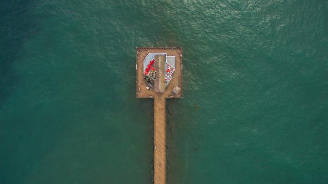Boat pier redumbrella man tiltshift free wallpaper - medium preview image