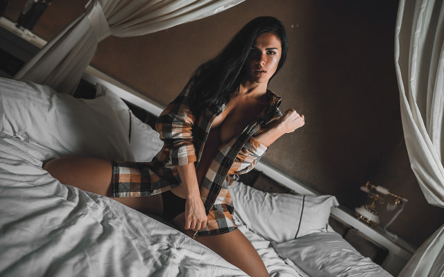 Woman plaid shirt bed sitting free wallpaper - medium preview image