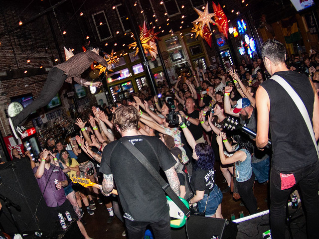 Crowd skateboard guitar man air free wallpaper - medium preview image