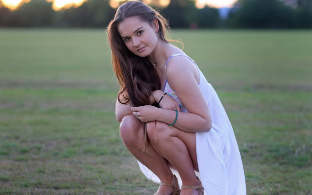 Woman white dress kneeling field free wallpaper - medium preview image