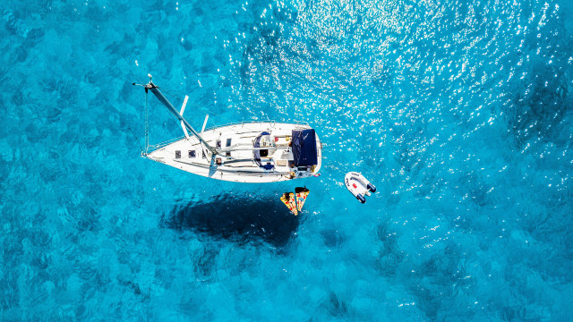 Small boat ocean larger boat free wallpaper - medium preview image