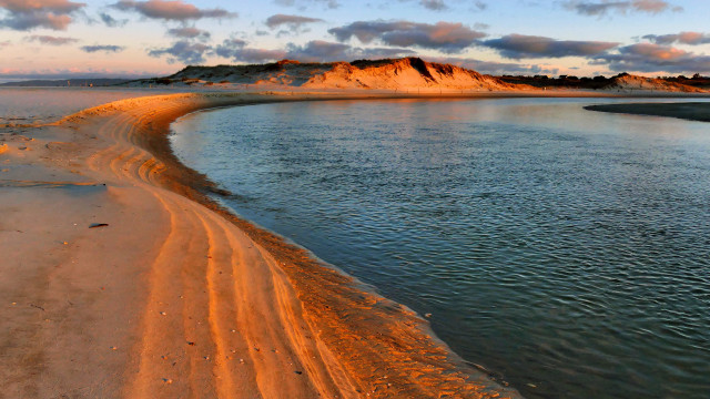 Sandy beach water hill clouds free wallpaper - medium preview image