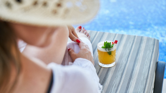 Woman pool drink closeup blurry free wallpaper - medium preview image