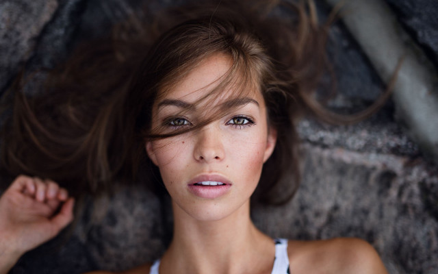 Woman laying rock blurry background free wallpaper for desktop - medium preview image