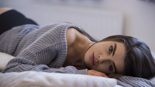 Woman bed gray sweater black free wallpaper - medium preview image