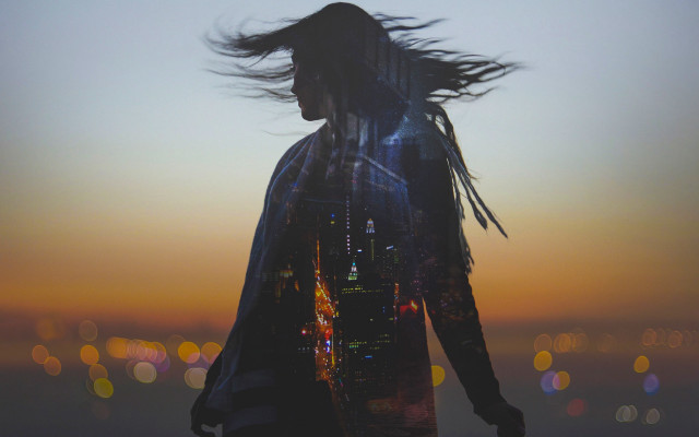 Woman blowing hair city sunset free wallpaper - medium preview image