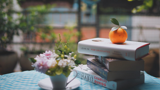 Stack books orange vase flowers free wallpaper - medium preview image