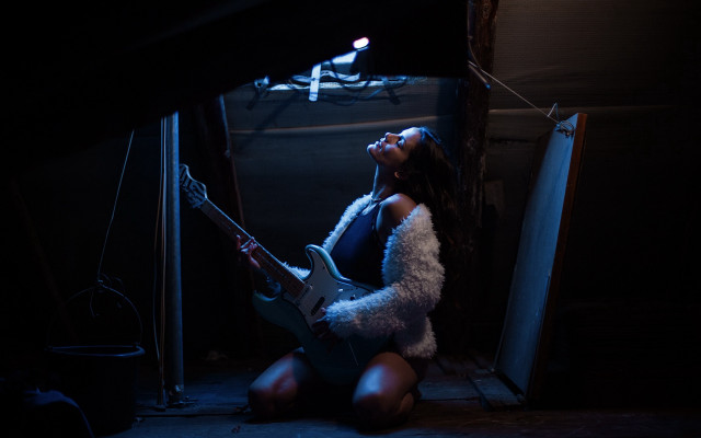 Woman playing guitar dark room free wallpaper - medium preview image