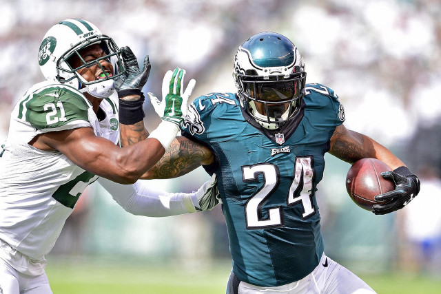 Football player holding ball blocking free wallpaper - medium preview image