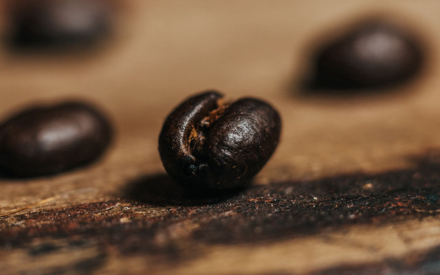 Coffee bean closeup wooden table free wallpaper - medium preview image