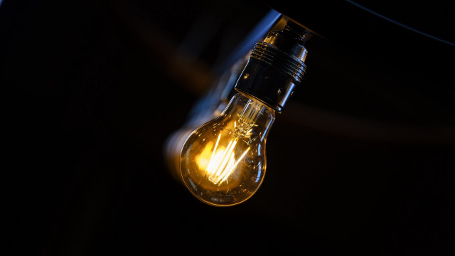 Glowing lightbulb dark space raytraced free wallpaper - medium preview image