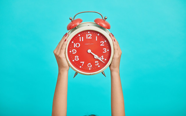 Person holding red clock blue free wallpaper - medium preview image