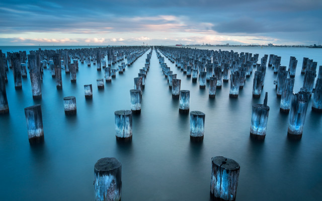 Water wooden posts sky cityscape free wallpaper - medium preview image