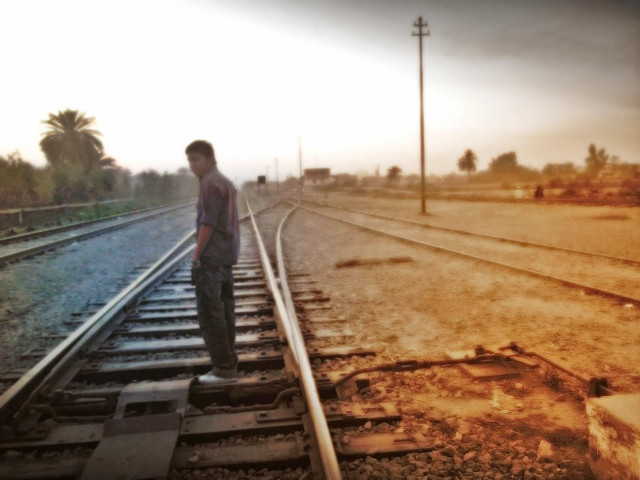Man standing train track sky free wallpaper - medium preview image
