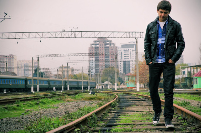 Man standing train track city free wallpaper for desktop - medium preview image