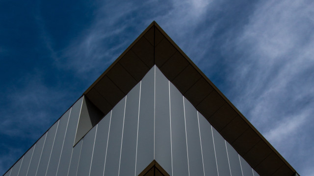 Building triangular roof blue sky free wallpaper - medium preview image