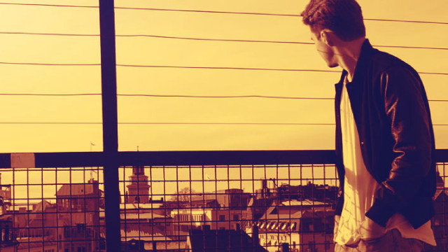 Man balcony laptop city fence free wallpaper - medium preview image