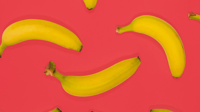 Bananas pink surface red background free wallpaper - medium preview image