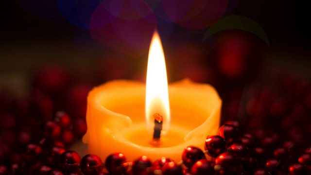 Lit candle red berries bokeh free wallpaper - medium preview image