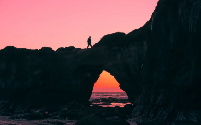 Person standing rock formation sunset free wallpaper - medium preview image