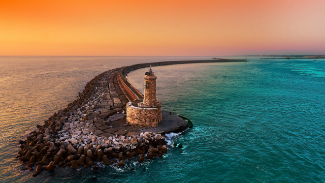 Lighthouse rock outcrop ocean sunset free wallpaper - medium preview image