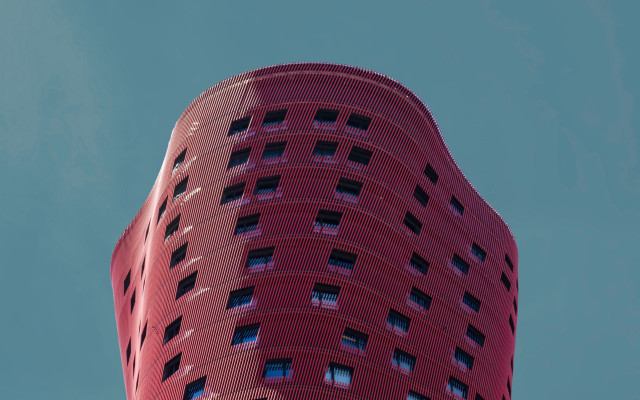 Tall red building sky plane free wallpaper - medium preview image
