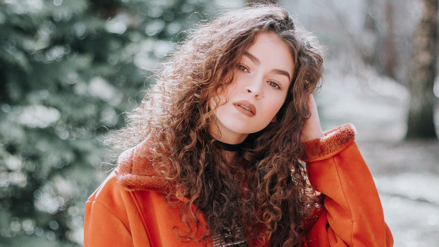 Woman curlyhair orangejacket woods portrait free wallpaper - medium preview image