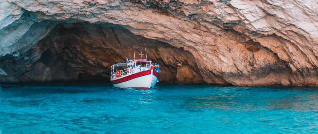 Ocean boat cave rock saturated free wallpaper - medium preview image