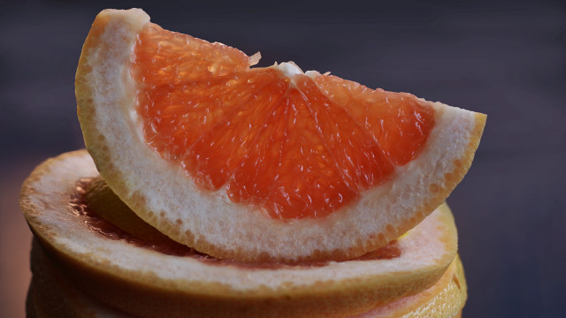 Grapefruit closeup blue black background free wallpaper - medium preview image