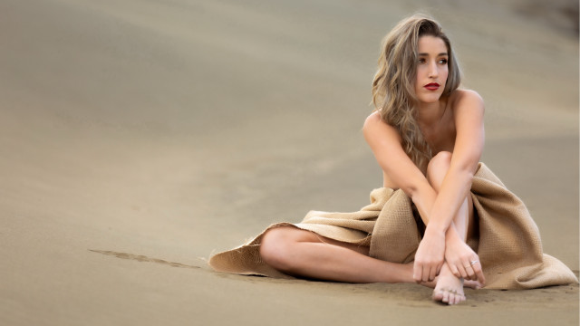 Woman beach towel sitting crossed free wallpaper - medium preview image
