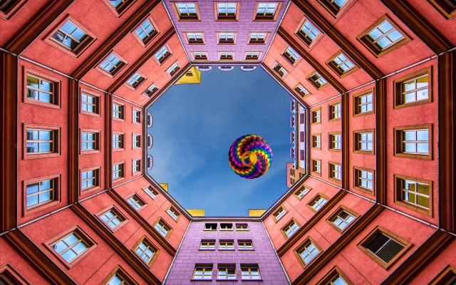 Colorful kite blue sky building free wallpaper - medium preview image