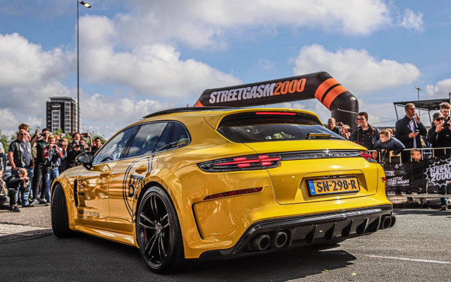 Yellow sportscar streetSign crowd panfuturism free wallpaper - medium preview image