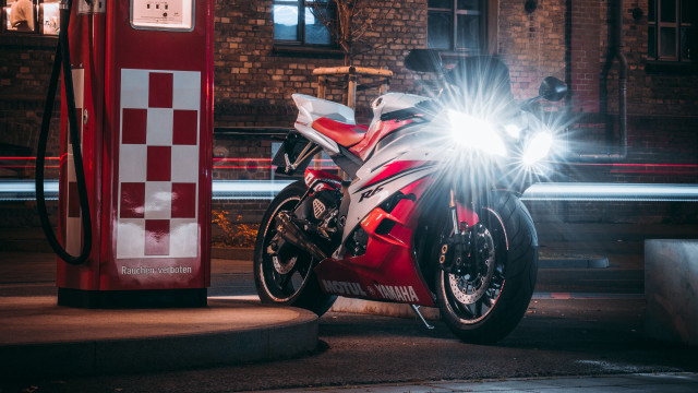 Red motorcycle gas pump cityscape free wallpaper - medium preview image