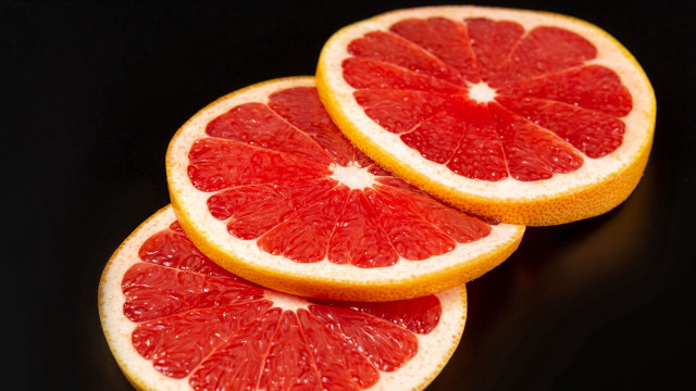Grapefruit slices black background food free wallpaper - medium preview image